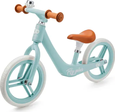 A light blue balance bike with brown handlebars and seat, shown against a white background.