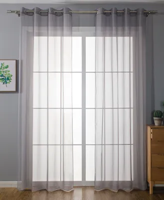 A window with sheer gray curtains covering it.
