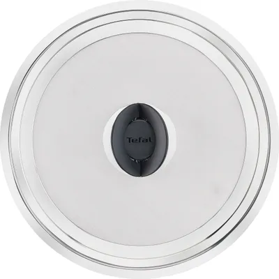 A top-down view of a round metal lid with a black and gray handle in the center.