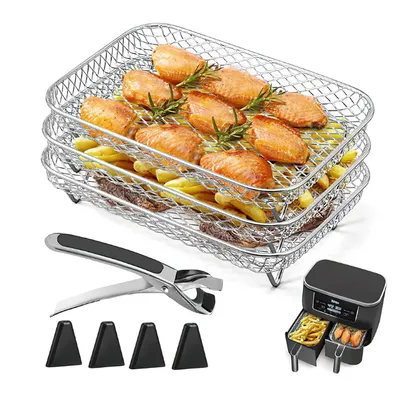 A set of air fryer accessories, including stacked wire racks, a gripper tool, and four triangular feet, is displayed against a white background. The top rack holds cooked chicken wings and rosemary sprigs, while the lower rack contains french fries.