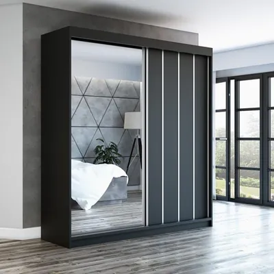 A modern bedroom with a sliding door wardrobe with mirrored doors.