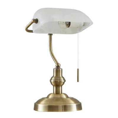 A bankers lamp with a bronze-colored base and stem, and a white frosted glass shade.
