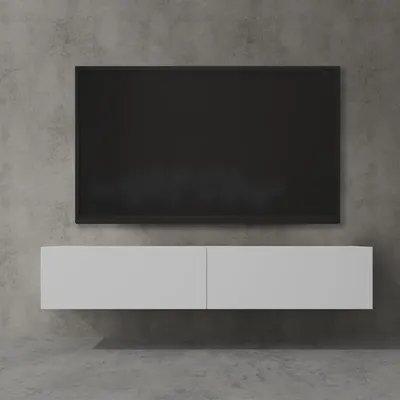 A modern TV lowboard mounted on a concrete wall, with a black TV screen above it.