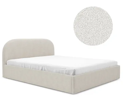 A bed with a curved headboard and a mattress.