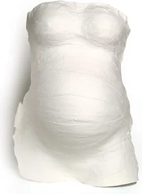 A white plaster cast of a pregnant belly, likely a DIY kit for creating a keepsake.