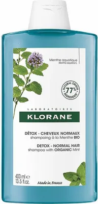 A bottle of Klorane shampoo with mint.