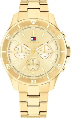 A close-up, front-facing studio shot of a gold Tommy Hilfiger women's watch against a white background.