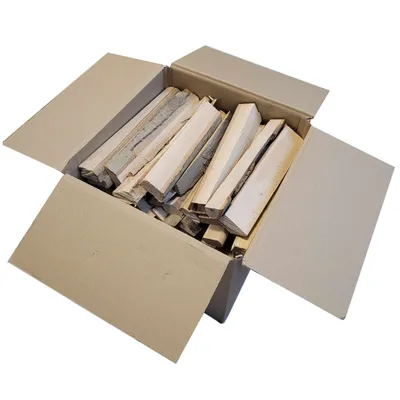 A cardboard box filled with pieces of firewood.