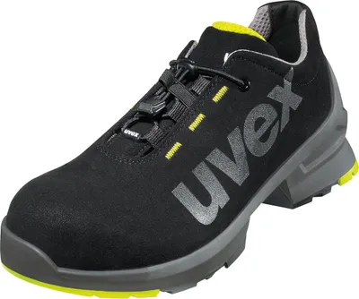 A black Uvex safety shoe with gray and yellow accents is shown against a white background.