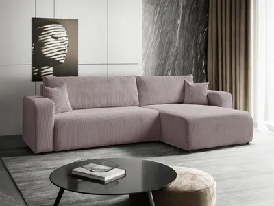 A modern living room with a sectional sofa, coffee table, and artwork.