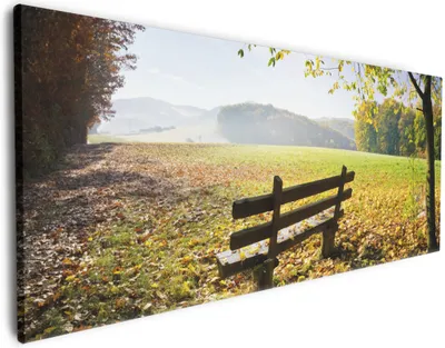 Produktbild von Wallario Premium Leinwandbild Idyllische Holzbank in den Bergen in Größe 80 x 200 cm