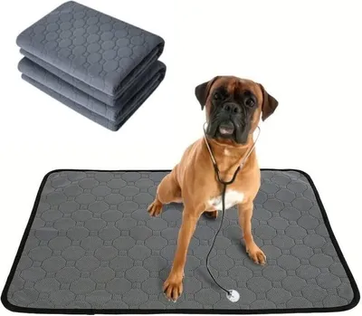 A boxer dog wearing a stethoscope sits on a gray pee pad, with a stack of similar pads in the background.