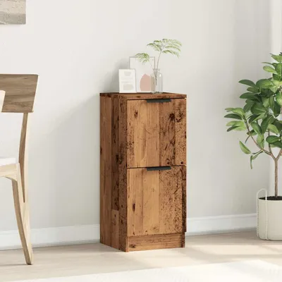 A wooden cabinet with two drawers is placed against a white wall, next to a potted plant and a chair.