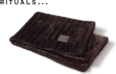 A brown plush blanket folded on a white background.