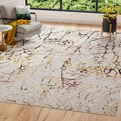 A rug is placed in a living room setting with a chair and a window in the background.