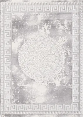 A top-down view of a rug with a distressed, marbled gray and white pattern and a central circular medallion.