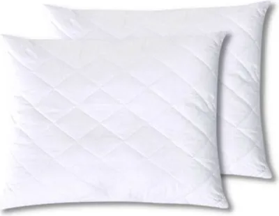 Two white quilted pillows are shown from a slightly elevated angle.