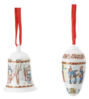 Two Christmas ornaments, a bell and an egg, hanging from red ribbons.