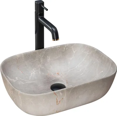 A beige oval countertop sink with a black faucet.