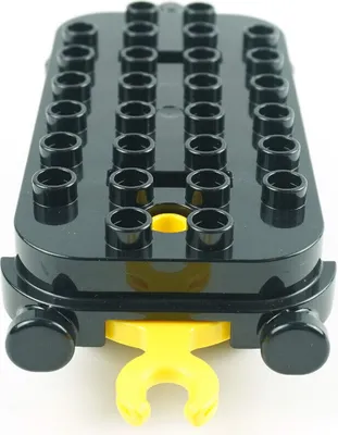 A black Lego Duplo train car chassis with a yellow coupling hook.