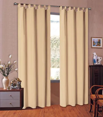 A pair of beige curtains hanging in front of a window, with a dresser and chairs visible to the sides.