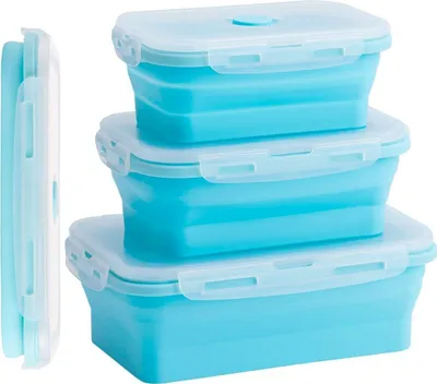 A stack of three blue silicone food storage containers with white lids, and one container folded flat on the left.