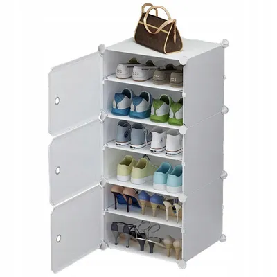 A modular shoe cabinet with shoes and a handbag on top.