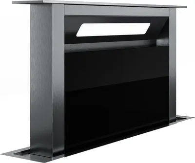 A modern downdraft extractor hood, made of brushed aluminum and black glass, is shown against a white background.