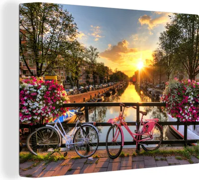 Zdjęcie produktu dla MuchoWow® - Obraz na płótnie - Amsterdam - Kwiaty - Most - Rower - Zachód słońca, fototapeta, dekoracja ścienna, obrazy do salonu, 120x90cm