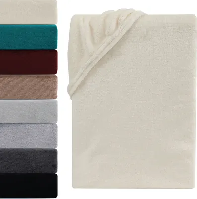 A stack of folded blankets in various colors is shown on the left, and a single cream-colored blanket is displayed on the right, folded and draped.