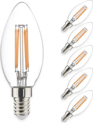 A group of clear LED filament light bulbs with silver bases are arranged on a white background. One bulb is in the foreground, and five are arranged diagonally behind it.