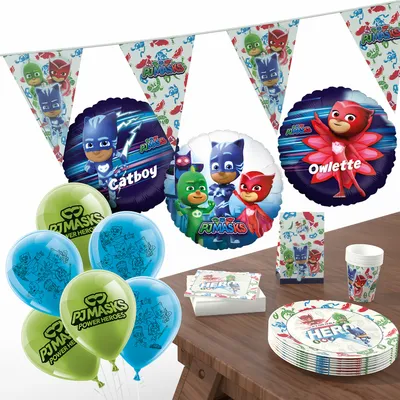 A collection of PJ Masks themed party supplies arranged on a wooden table.