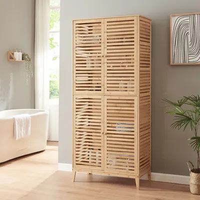 A bathroom with a bathtub and a tall wooden cabinet.