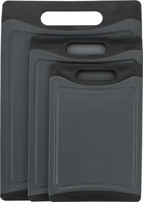 Three dark gray cutting boards of different sizes are stacked on top of each other.