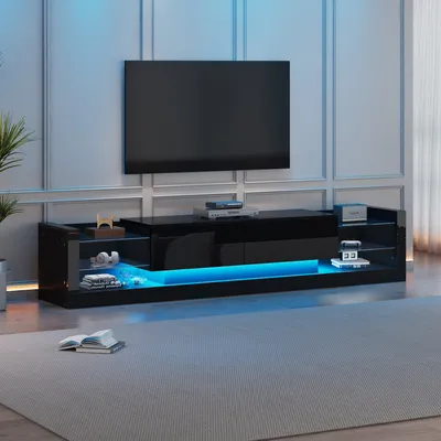 A modern black TV stand with LED lighting, displaying a large flat-screen TV above it.