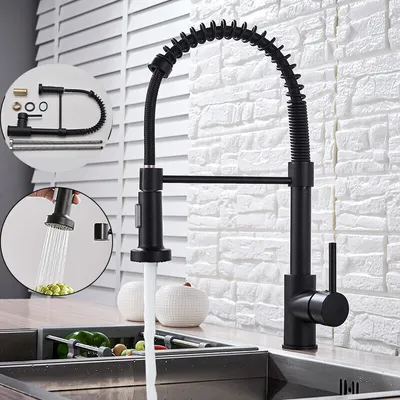 A black pull-down kitchen faucet with a coiled hose is shown in a kitchen sink setting.