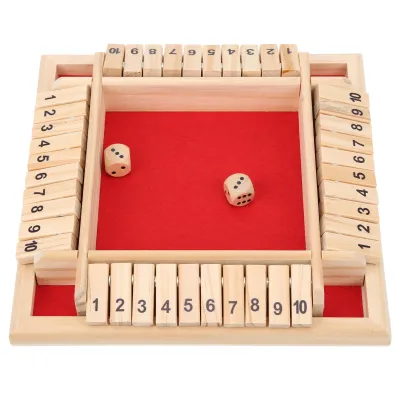 A wooden dice game with numbered tiles on a red felt surface.