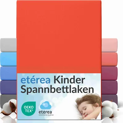 A stack of colorful fitted sheets with a child sleeping on a pillow in the foreground.
