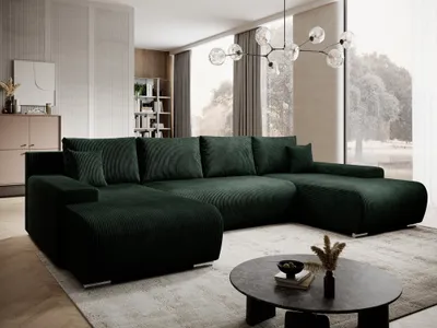 A modern living room with a large, dark green sectional sofa as the focal point.