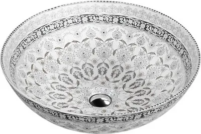 A white porcelain sink with intricate black and gray floral patterns.