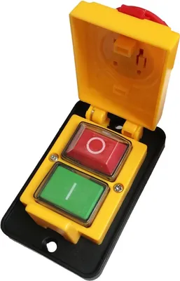 A yellow and black industrial switch with red and green buttons.