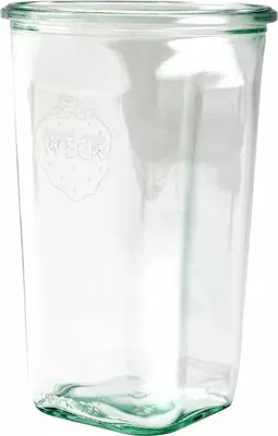 A clear glass jar with a logo embossed on the side.