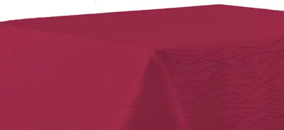 A close-up view of a red tablecloth draped over a table corner.
