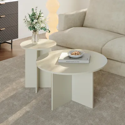 A living room scene with two round side tables, a sofa, and a cabinet.