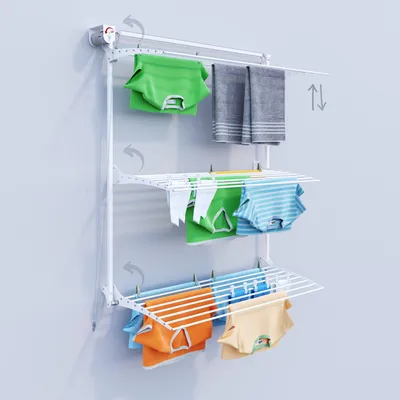 A white wall-mounted drying rack with clothes hanging on it.