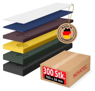 A stack of colored plastic glazing blocks with a cardboard box and a 'Made in Germany' tag.