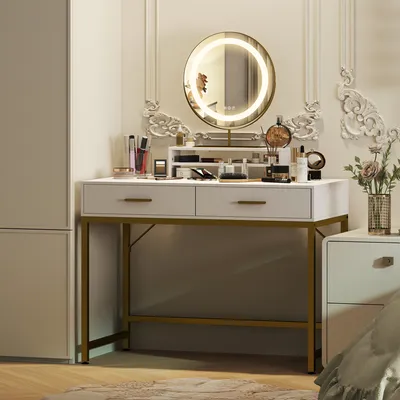 A white vanity table with gold legs, featuring a round LED mirror and various makeup products.