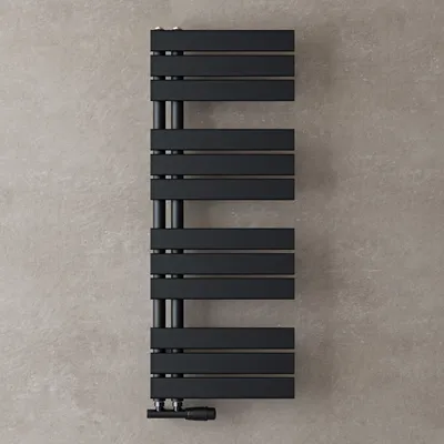 A black radiator mounted on a gray textured wall.