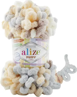 A ball of Alize Puffy Color yarn is shown, partially wrapped around its cylindrical packaging.