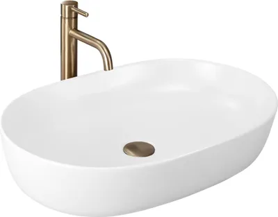 A white oval washbasin with a bronze faucet and drain.